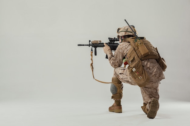 Soldier in camouflage holding rifle Premium Photo