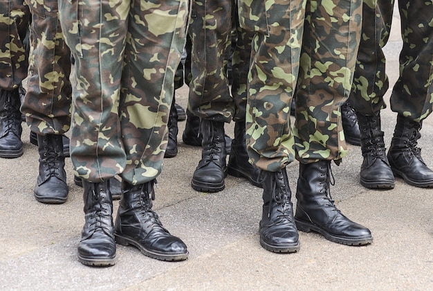 Premium Photo | Soldiers feet in camouflage military uniforms