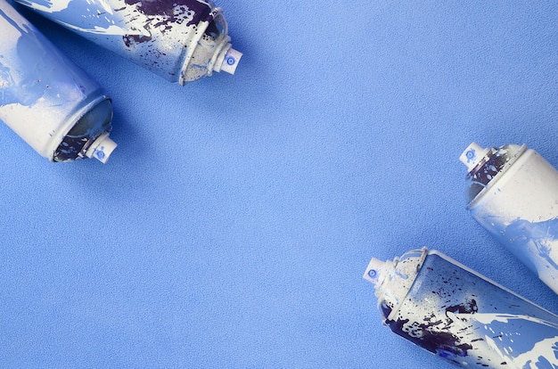 Premium Photo | Some used blue aerosol spray cans with paint drips lies ...