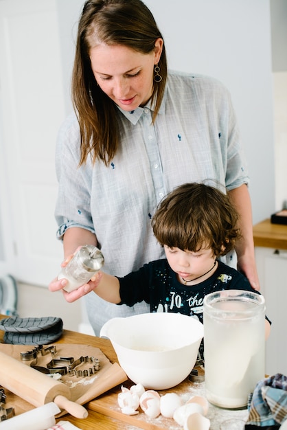 Premium Photo | Son helps mother cook in the kitchen