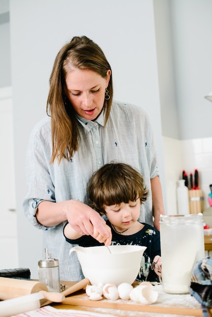 Premium Photo | Son helps mother cook in the kitchen