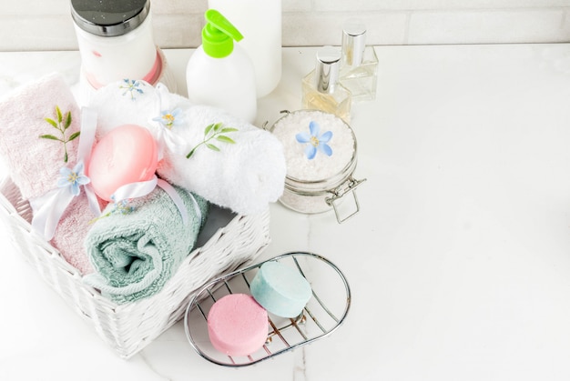 Spa relax and bath concept, sea salt, soap, with cosmetics and towels in bathroom Premium Photo