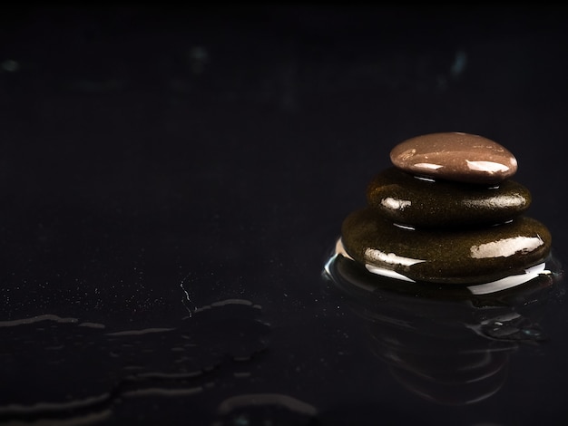 Premium Photo Spa Stones Black Shiny Zen Stones With Water Drops Over Black Wall