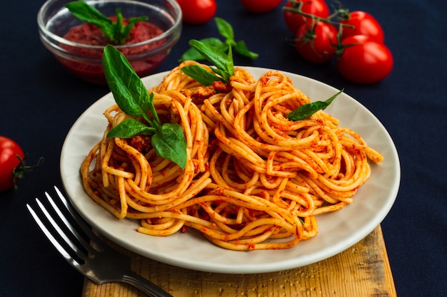 Premium Photo | Spaghetti bolognese in a plate on blue