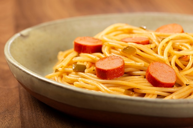 Premium Photo | Spaghetti pasta with sliced sausages and tomato sauce