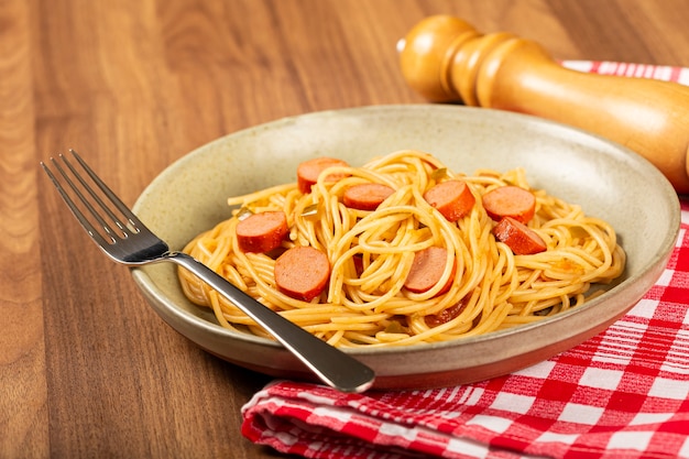 Premium Photo | Spaghetti pasta with sliced sausages and tomato sauce