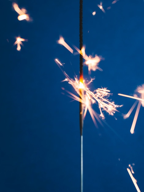 Sparkler stick on blue | Free Photo