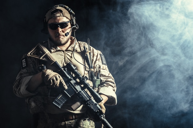 Premium Photo | Special forces soldier with rifle on dark