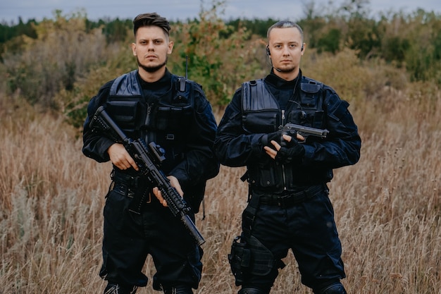 Premium Photo | Special forces soldiers in black uniform with guns