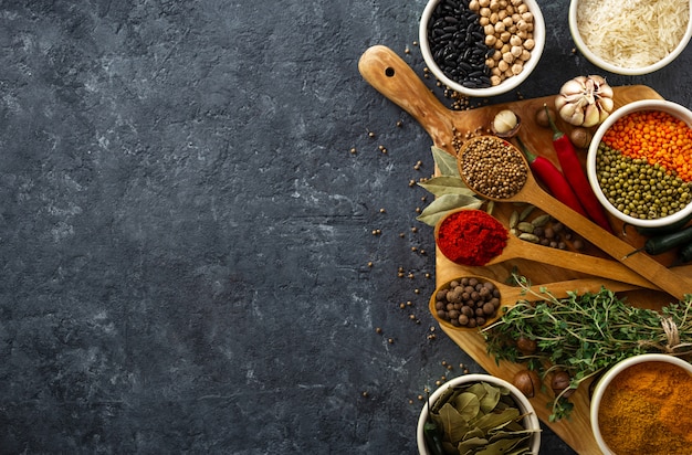 Spices, herbs, rice and various beans and seasonings for cooking on dark backgraund with copyspace top view Premium Photo