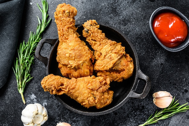 Spicy Deep Fried Breaded Chicken Drumsticks On Black Table Premium Photo