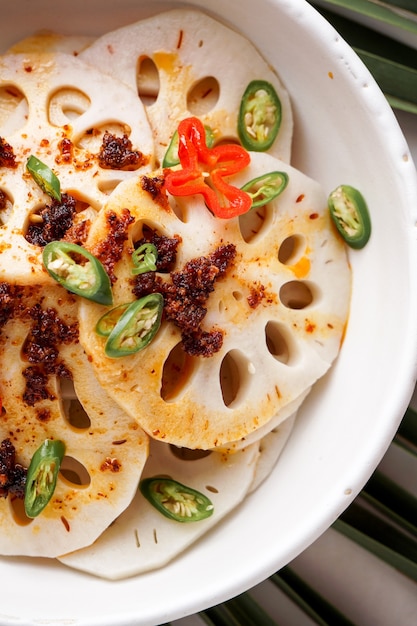 Premium Photo | Spicy lotus root salad on the white stone background ...