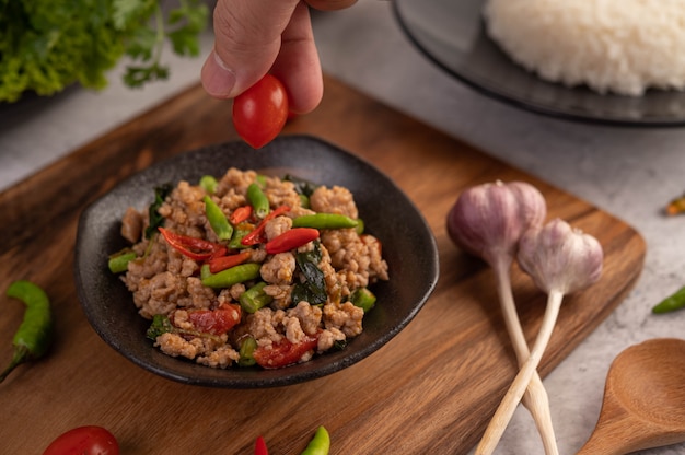 Free Photo | Spicy minced pork and rice on a black plate.