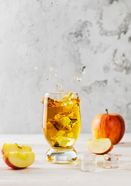 Premium Photo | Splashing apple juice in a glass