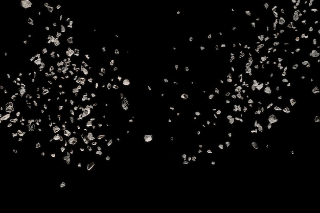 Premium Photo | Split debris of stone exploding against black background.