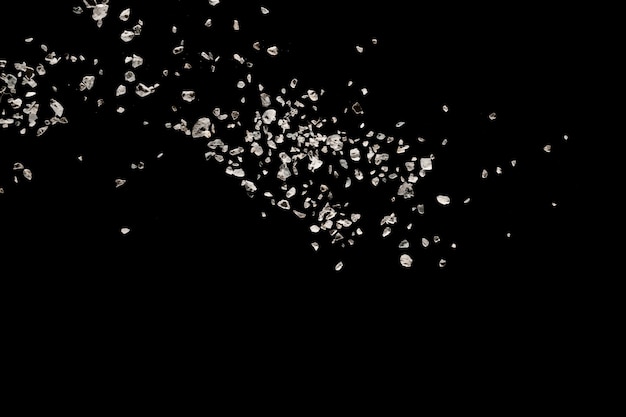 Premium Photo | Split debris of stone exploding against black background.