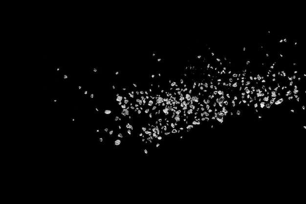 Premium Photo | Split debris of stone exploding against black background.