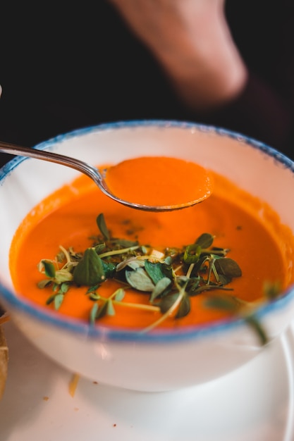 Download Spoon of soup above bowl of soup | Free Photo