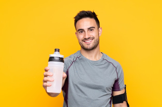 Download Premium Photo Sport Man Over Yellow Wall With Sports Water Bottle PSD Mockup Templates