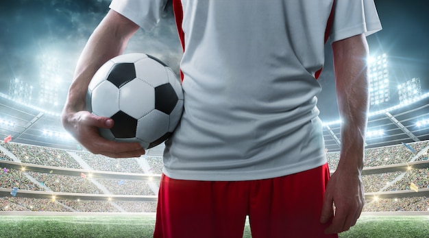 Premium Photo Sport Professional Soccer Player Holding Soccer Ball On The Stadium Close Up