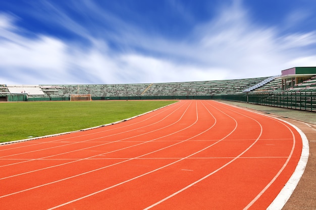 Premium Photo | Sport stadium with running track lines blue sky background.