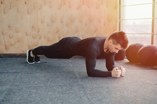 Premium Photo | Sports guy doing plank exercise. gym and sports ...