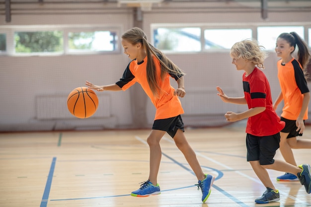 Premium Photo | Sports time. kids in bright sportswear playing ...