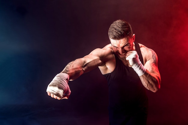 Premium Photo | Sportsman muay thai boxer fighting on black background ...