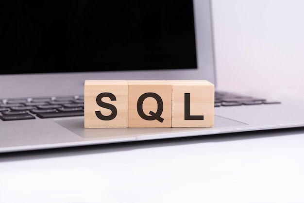 premium-photo-sql-wooden-cubes-with-letters-on-a-silver-laptop-keyboard-sql-short-for