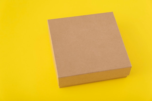 Download Premium Photo | Square cardboard box on a yellow background. copy space. mock up