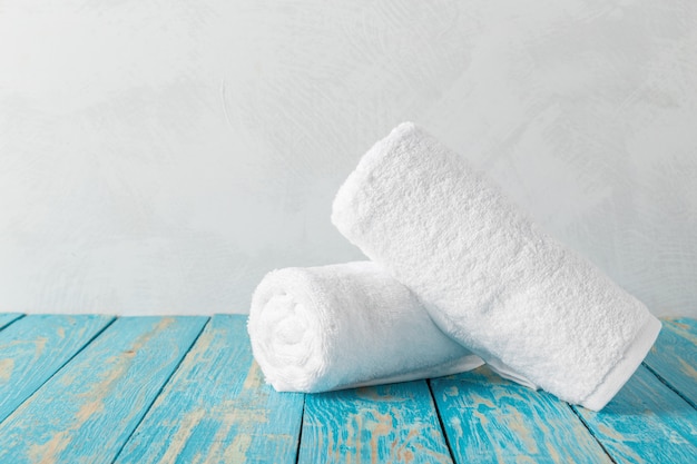 Stack of bath towels on wooden table with copy space Premium Photo