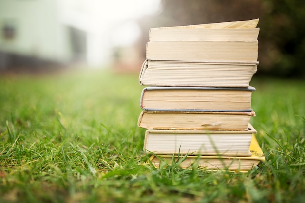 Stack of books on lawn Photo | Free Download