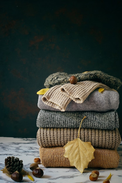 Free Photo | Stack of cozy knitted sweaters. autumn-winter concept, knitted wool sweaters. pile ...
