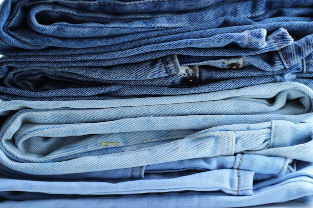 Premium Photo | Stack of folded jeans on the table