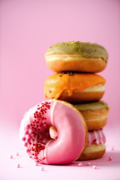 Premium Photo | Stack of glazed colorful assorted donuts with sprinkles ...