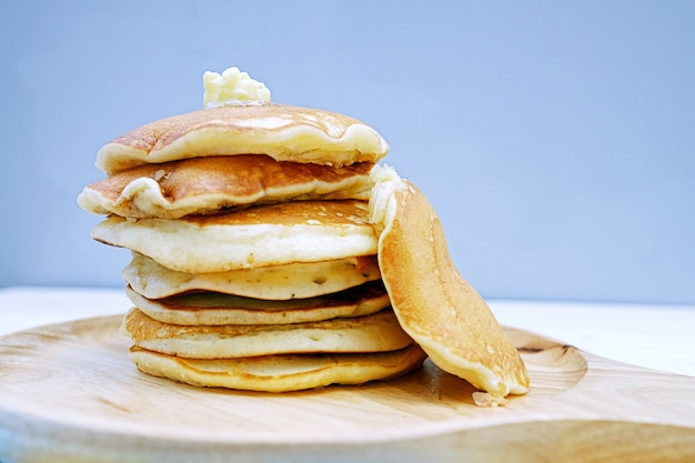 Premium Photo | Stack of pancakes in wooden tray on table