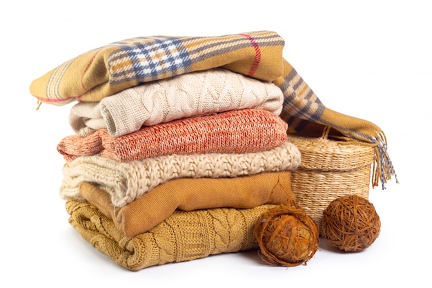 Premium Photo | Stack of various sweaters isolated on white