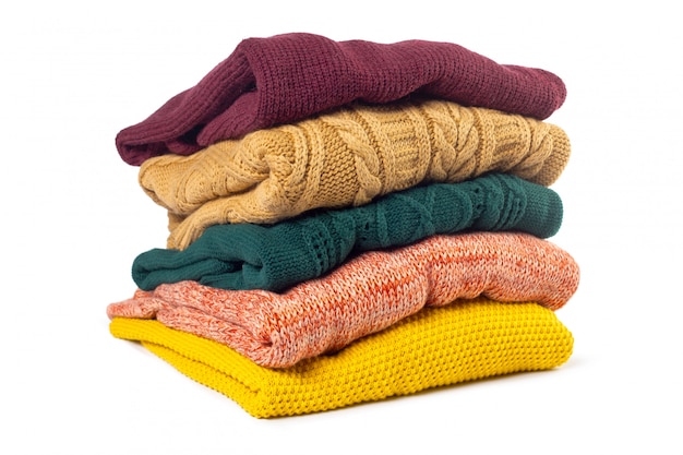 Premium Photo | Stack of various sweaters isolated on white