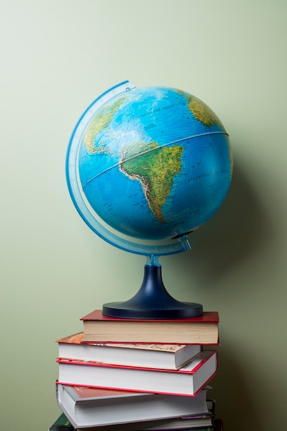 Stacked books with globe Photo | Free Download