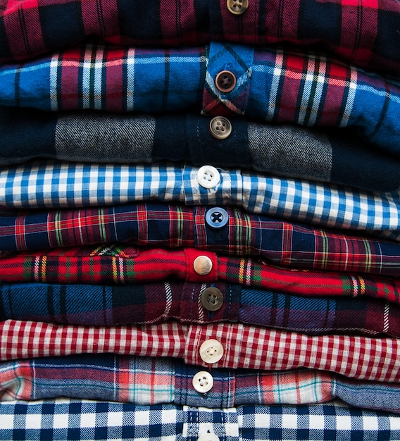 Premium Photo | Stacks of checkered shirts