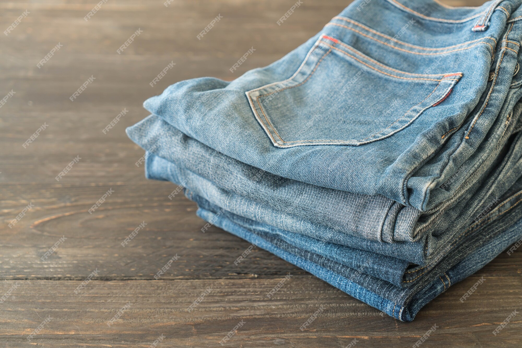 Free Photo | Stacks of jeans clothing on wood