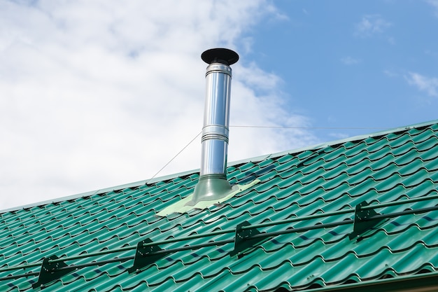 Premium Photo Stainless Steel Metal Chimney Pipe On The Roof Of The House Against The Sky