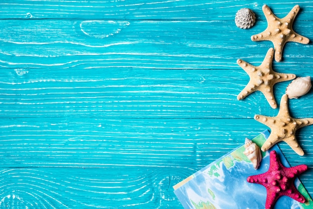 Starfish and nap located on blue wooden background Photo | Premium Download