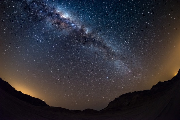 Starry sky and milky way arch, with details of its colorful core, outstandingly bright, captured from the namib desert in namibia. Premium Photo