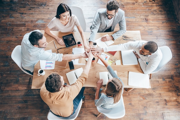 Premium Photo | Starting new working day as a team. top view of group ...