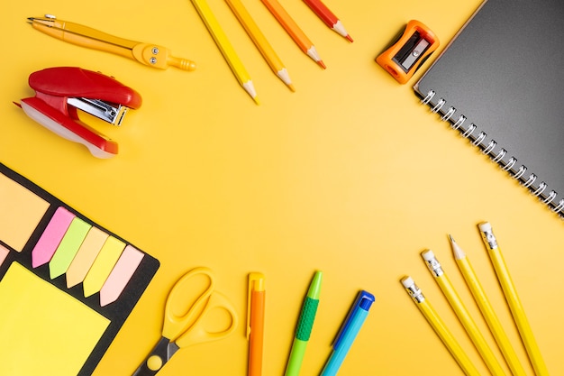 Premium Photo | Stationery on a yellow background.