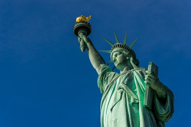 Premium Photo | The statue of liberty at liberty island and blue sky ...