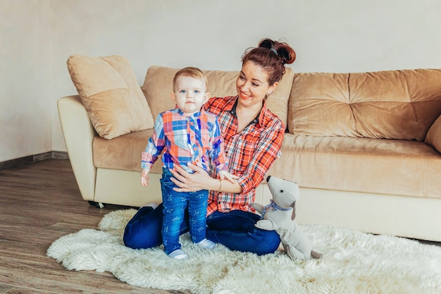 Premium Photo | Stay home stay safe. young mother holding her child ...