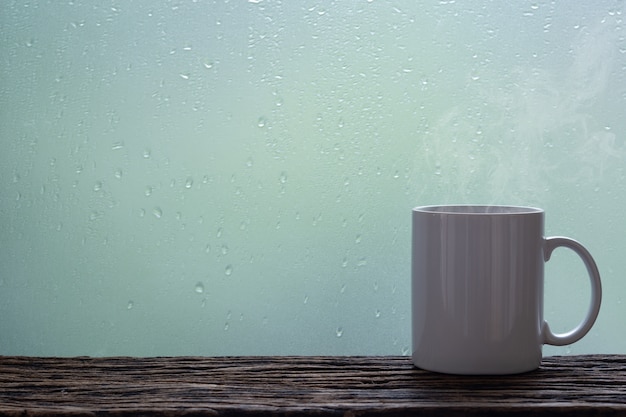 Premium Photo Steaming Coffee Cup On A Rainy Day Window Background