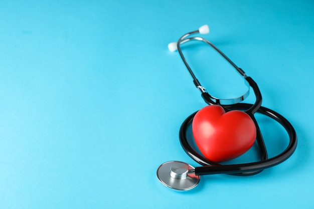 Premium Photo | Stethoscope and heart on blue background, space for ...